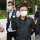 Ryan Law, second from right, Apple Daily’s chief editor, is arrested by police officers in Hong Kong Thursday, June 17, 2021.